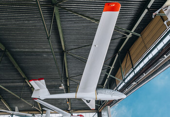 glider suspended in the hangar  - obrazy, fototapety, plakaty