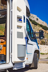 Camper door with trash can.