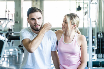 Fototapeta na wymiar Smart sport man and woman working out in fitness gym