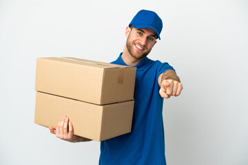 Delivery man over isolated white background pointing front with happy expression