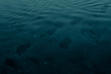 Fototapeta na wymiar Footprints on the bottom of a lake or river under water