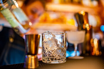 woman bartender hand making negroni cocktail. Negroni classic cocktail and gin short drink with sweet vermouth, red bitter liqueur