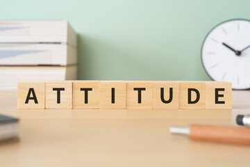 態度のイメージ｜「ATTITUDE」と書かれたブロックが置かれたデスク
