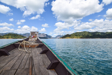 Wood boat on river with beautiful cloud