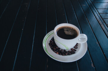 Black coffee in Coffee cup on wood and spac background