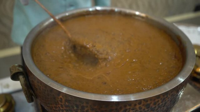 Extreme close up shot of Dal makhani or Black Tarka fry is a popular food from Punjab and India made using whole black lentil, red kidney beans, butter and cream and sweet fragrant spices.