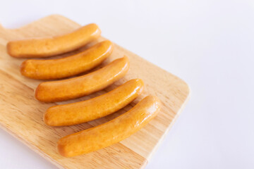 Sausage on wooden cutting board.