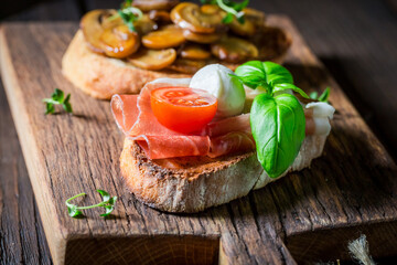 Crisp and hot various bruschetta as classic snack for breakfast.