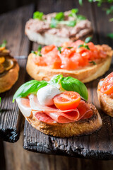 Homemade mix of bruschetta with fresh ingredients for breakfast.