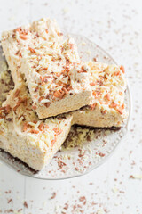 Cake with white chocolate and meringue on white table