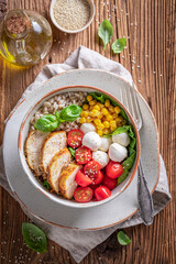 Fit Caesar salad with groats, chicken and tomatoes.