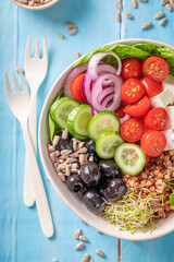 Colorful Greek salad with vegetables, cheese and buckwheat groats.