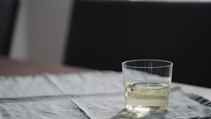 white wine in glass on walnut table