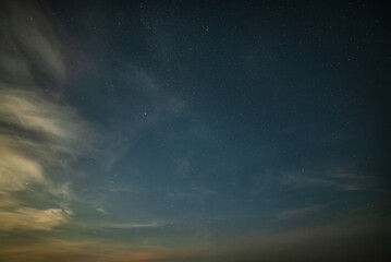 Naklejka na ściany i meble Beautiful noctilucent cloud formations against Milky Way background night sky