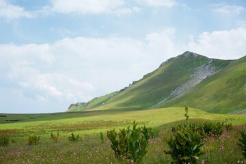 Fototapeta premium Summer mountain landscape. High mountains and above the mountains a bright blue sky