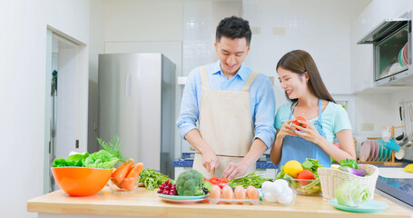 couple are cutting vegetable