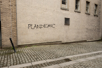A street in Scotland with plandemic conspiracy theory daubed on the wall - 518917188