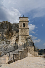 Fototapeta na wymiar The tower of a church carved into the rock in Pietracupa, a mountain village in the Molise region in Italy.