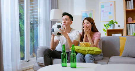 happy couple cheering football game