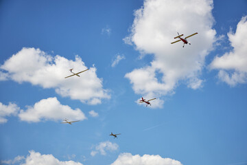 Five sports planes against the blue sky.