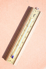 wooden weather thermometer in a really hot day
