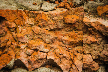 Red brick wall. Remains of a demolished house.