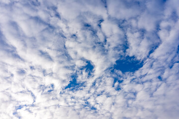 White cumulus clouds in a bright blue sky