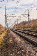 Railroad and power pylons in autumn season.  Landscape