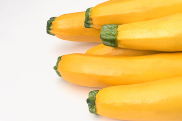 Obraz na płótnie Canvas Yellow zucchini raw vegetables on white paper