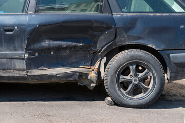 Obraz na płótnie Canvas Damaged blue car after accident left outdoors. Cropped vehicle