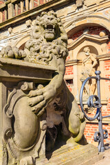 Fototapeta na wymiar Statue of lion at the entrance to Frederiksborg castle in Hillerod, Denmark