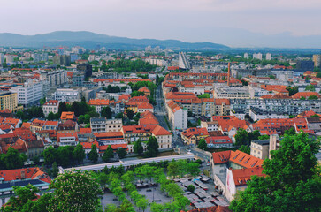 Fototapeta na wymiar Aerial panoramic view of Ljubljana, capital of Slovenia in warm sunset light. Travel destination. Red roofs.