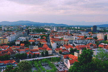 Obraz premium Aerial panoramic view of Ljubljana, capital of Slovenia in warm sunset light. Travel destination. Red roofs.