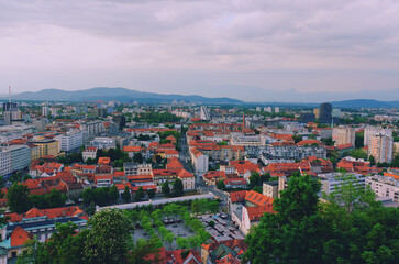Fototapeta na wymiar Aerial panoramic view of Ljubljana, capital of Slovenia in warm sunset light. Travel destination. Red roofs.