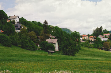 Fototapeta na wymiar village on the green hills in the Alps mountains. Europe. Slovenia. Rural landscape.
