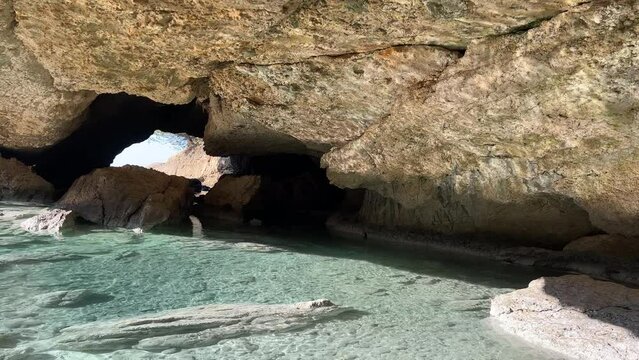 Sea cave grotto in blue paradise lagoon.
