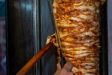 Doner kebab popular fast food  cooked on a vertical rotisserie.