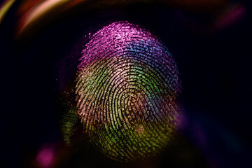 Close up beautiful abstract neon colored fingerprint on  background texture for design. Macro...
