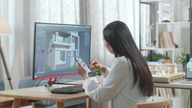 Asian Woman Engineer Using Smartphone While Designing House On A Desktop At Home. Cyber Games House Design And Decoration
