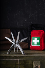 Multifunctional knife for hunters and tourists. Tool and first aid kit. Vertical frame.