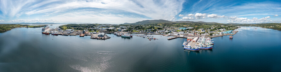 Fototapeta na wymiar Aerial view of Killybegs with huge cruise ship in County Donegal - Ireland - All brands and logos removed