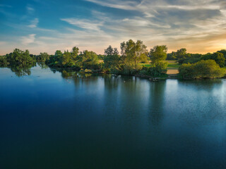 Calm water lake that looks like a mirror at sunset