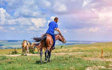 man on a horse in the mountains