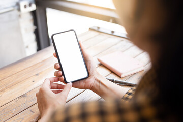 cell phone blank white screen mockup.hand holding texting using mobile on desk at office.background empty space for advertise.work people contact marketing business,technology
