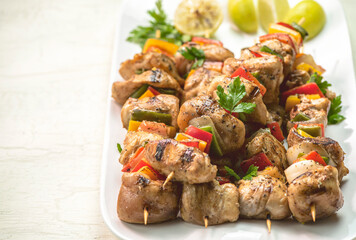 Arabic cuisine; Traditional grilled chicken Shish Kebabs or Shish Tawook on skewers. Close up with copy space. 