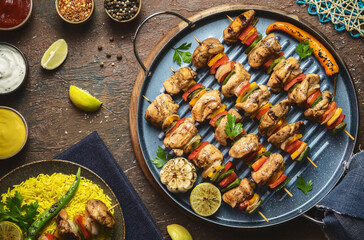 Arabic cuisine; Traditional grilled chicken Shish Kebabs or Shish Tawook on skewers. Close up with copy space. 