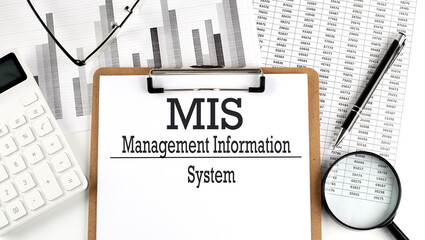 Paper with MIS on a chart with calculator,pen and magnifier © Iryna