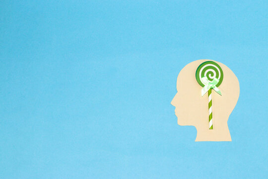 paper head with brain lollipop, creative art design and copy space, blue background
