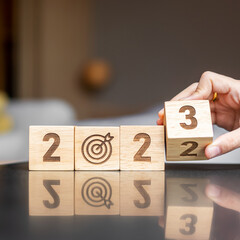 hand flip 2022 to 2023 block with dartboard sign. Business Goal, Target, Resolution, strategy,...