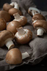 Close up of shiitake mushrooms on kitchen textile raw food cooking concept